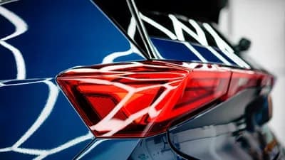Close-up of red tail light on blue car